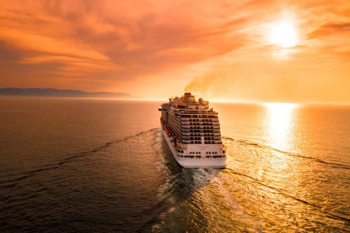 cruise ship sailing into the sunset