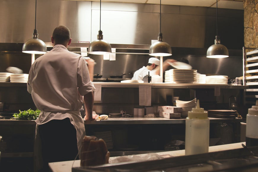 Chef and assistant working in hotel kitchen